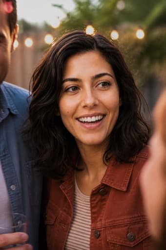 The same sample person laughing in a candid photo cropped from a group at a party