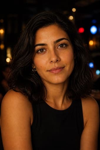 The same sample person photographed in dim evening light at a bar